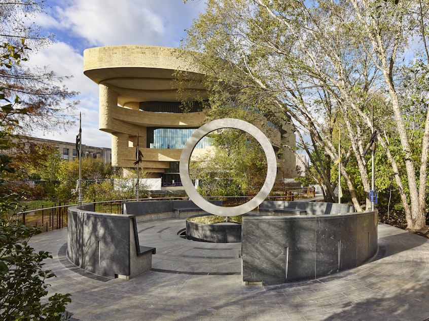 caption: The National Native American Veterans Memorial designed by signed by Harvey Pratt on the grounds of the National Museum of the American Indian in Washington, D.C.