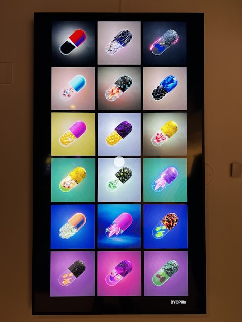 caption: BYOPills creates purchasable metaverse accessories, with a variety displayed at the museum. 