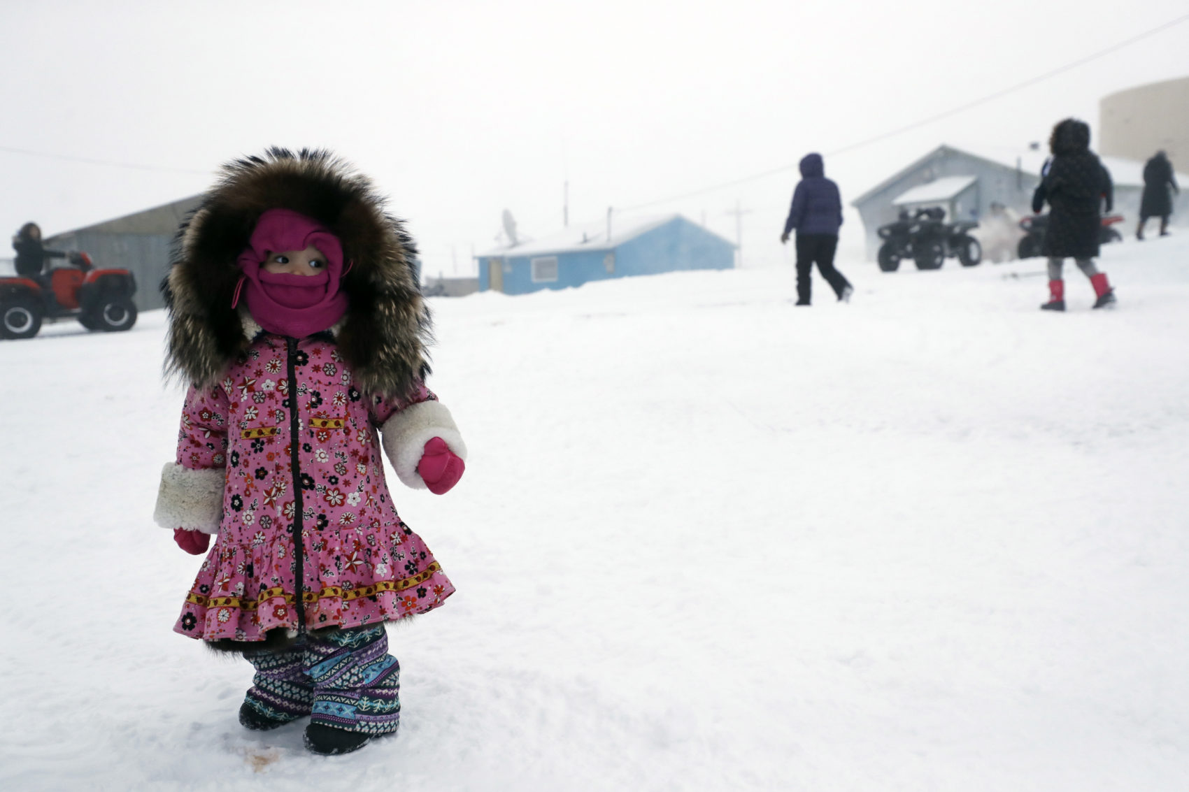 caption: A girl waits for her mother on Jan. 19 in Toksook Bay, Alaska. The first Americans to be counted in the 2020 Census starting Tuesday live in this Bering Sea coastal village. The Census traditionally begins earlier in Alaska than the rest of the nation because frozen ground allows easier access for Census workers, and rural Alaska will scatter with the spring thaw to traditional hunting and fishing grounds. (Gregory Bull/AP)
