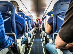 caption: Despite a new Congressional mandate to set minimum seat widths and legroom standards, the FAA is unlikely to expand airline seat size anytime soon.