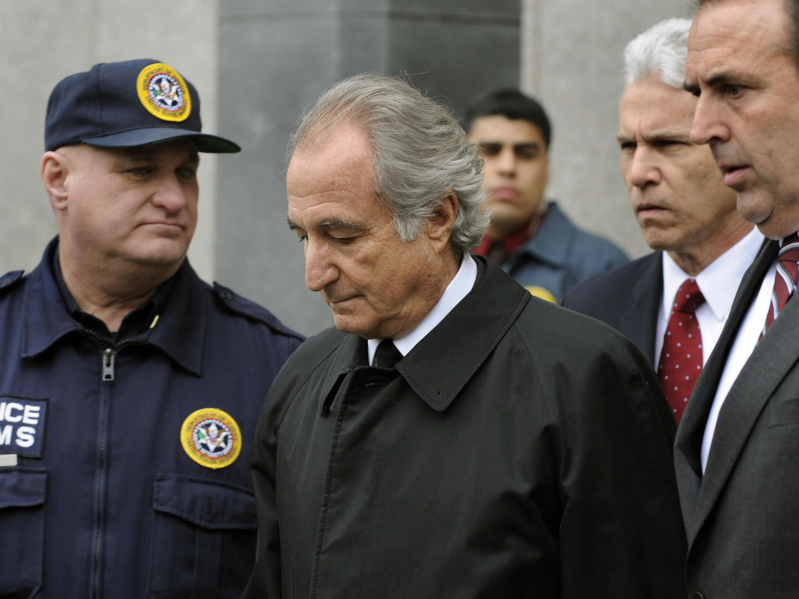 caption: Disgraced Wall Street financier Bernard Madoff leaves US Federal Court after a hearing on March 10, 2009 in New York. Ten years later, victims of his scam are still rebuilding their lives.