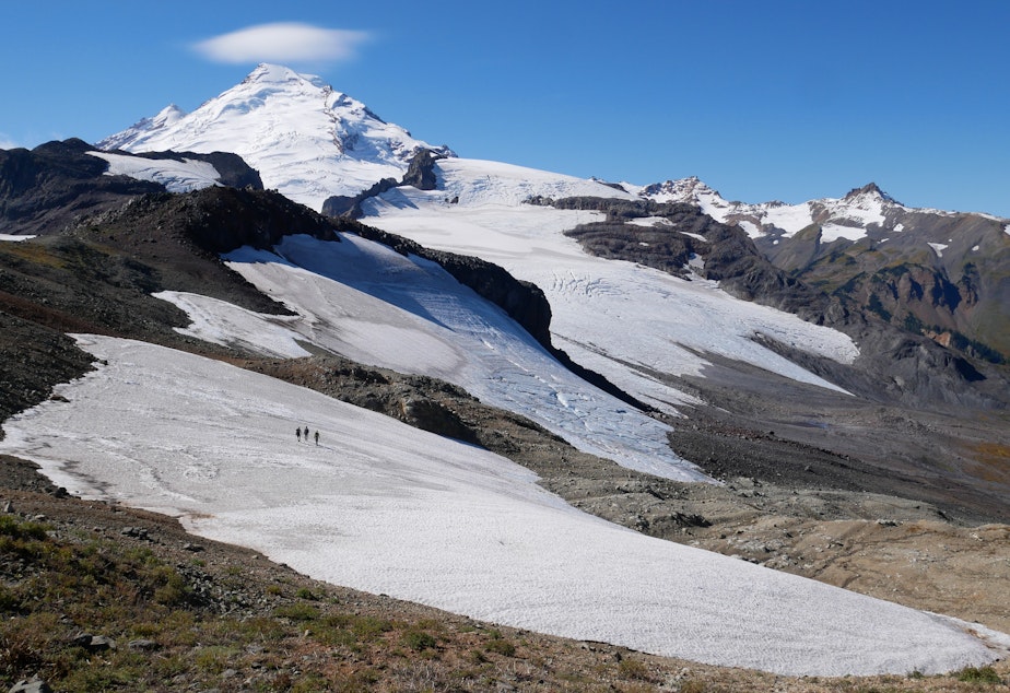 caption: Nooksack Tribe glacier researchers cross a snowfield on their way to the Sholes Glacier on Mount Baker.