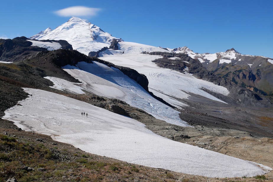 caption: Nooksack Tribe glacier researchers cross a snowfield on their way to the Sholes Glacier on Mount Baker.