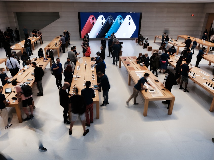 caption: People shop at the Fifth Avenue Apple Store in September in New York City. Apple says customers who want to repair their own devices will be able to buy the parts and tools to do so for certain products starting early next year.