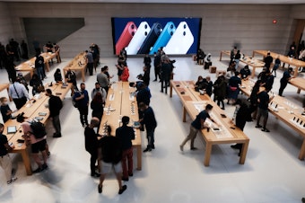 caption: People shop at the Fifth Avenue Apple Store in September in New York City. Apple says customers who want to repair their own devices will be able to buy the parts and tools to do so for certain products starting early next year.