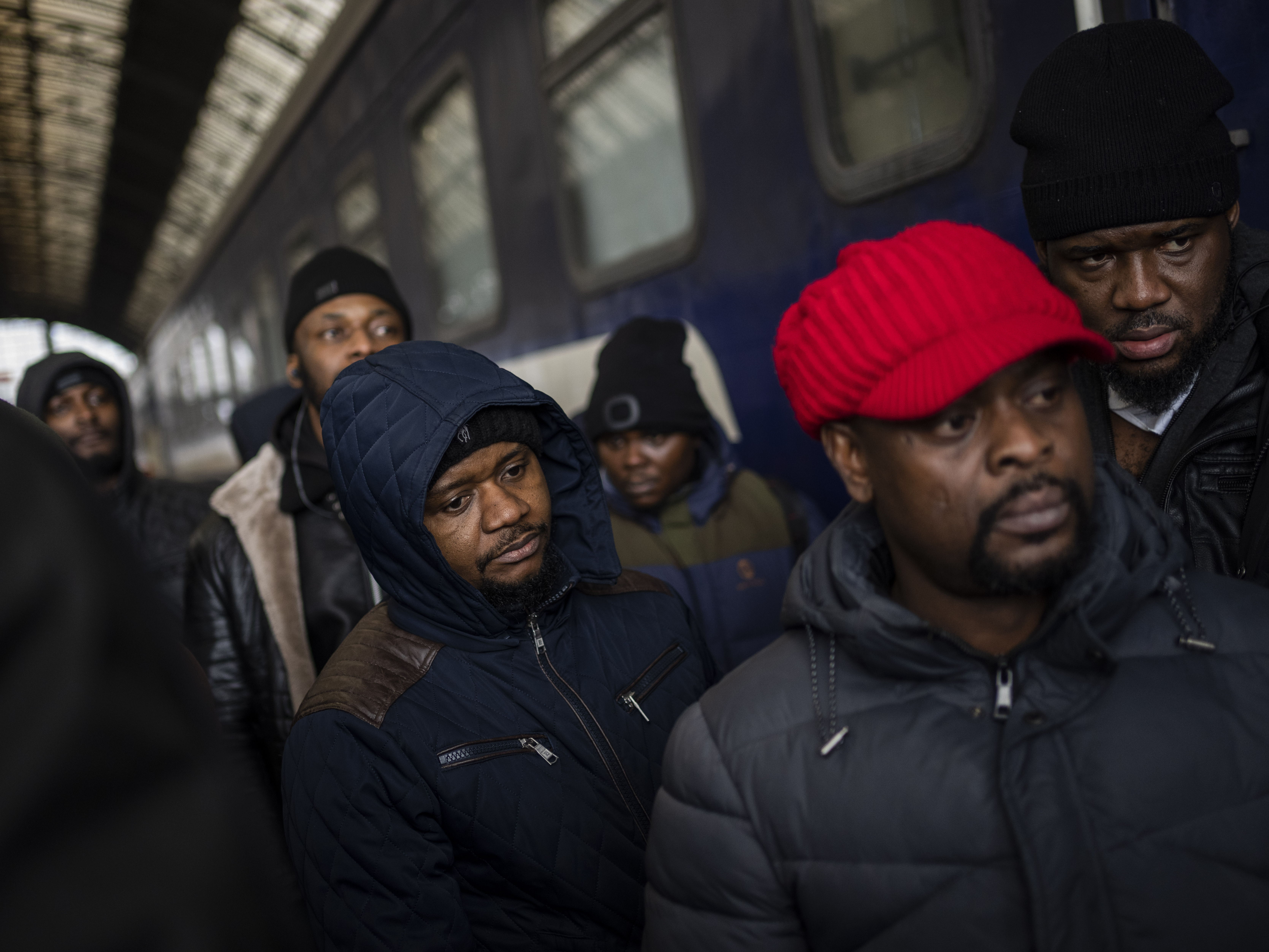 caption: African residents in Ukraine wait at the platform inside the Lviv railway station on Sunday in Lviv in western Ukraine.
