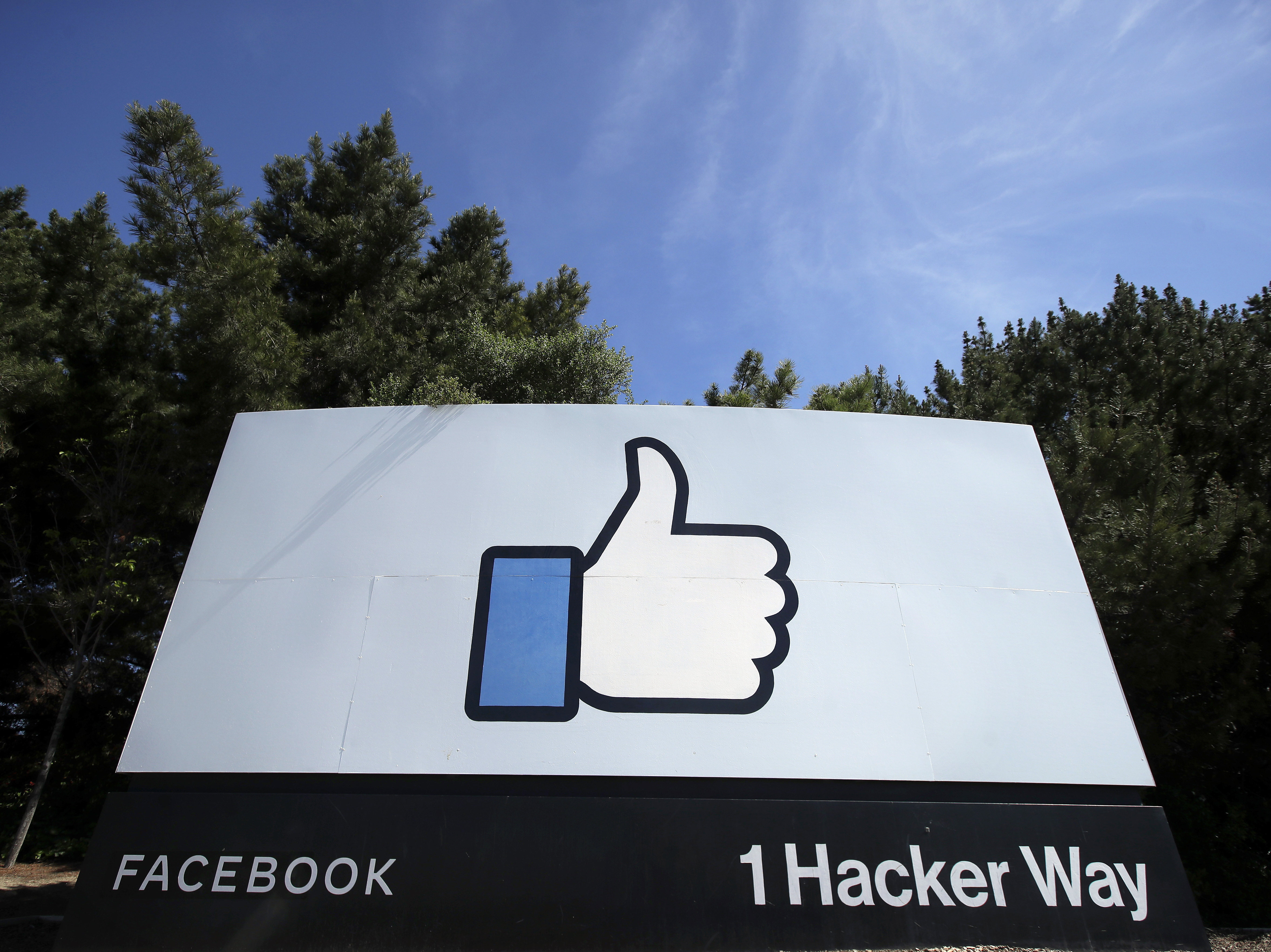 caption: The thumbs-up Like logo on a sign at Facebook headquarters in Menlo Park, Calif. The Justice Dept. is suing the company for allegedly discriminating against U.S. workers in favor of temporary visa holders.