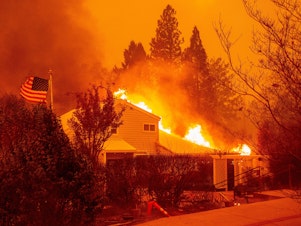 caption: A home burns during the Camp Fire in Paradise, Calif., in November 2018. It was one of several fires often discussed in terms of the changing climate. A new survey shows a jump in the number of Americans who are "very worried" about global warming.