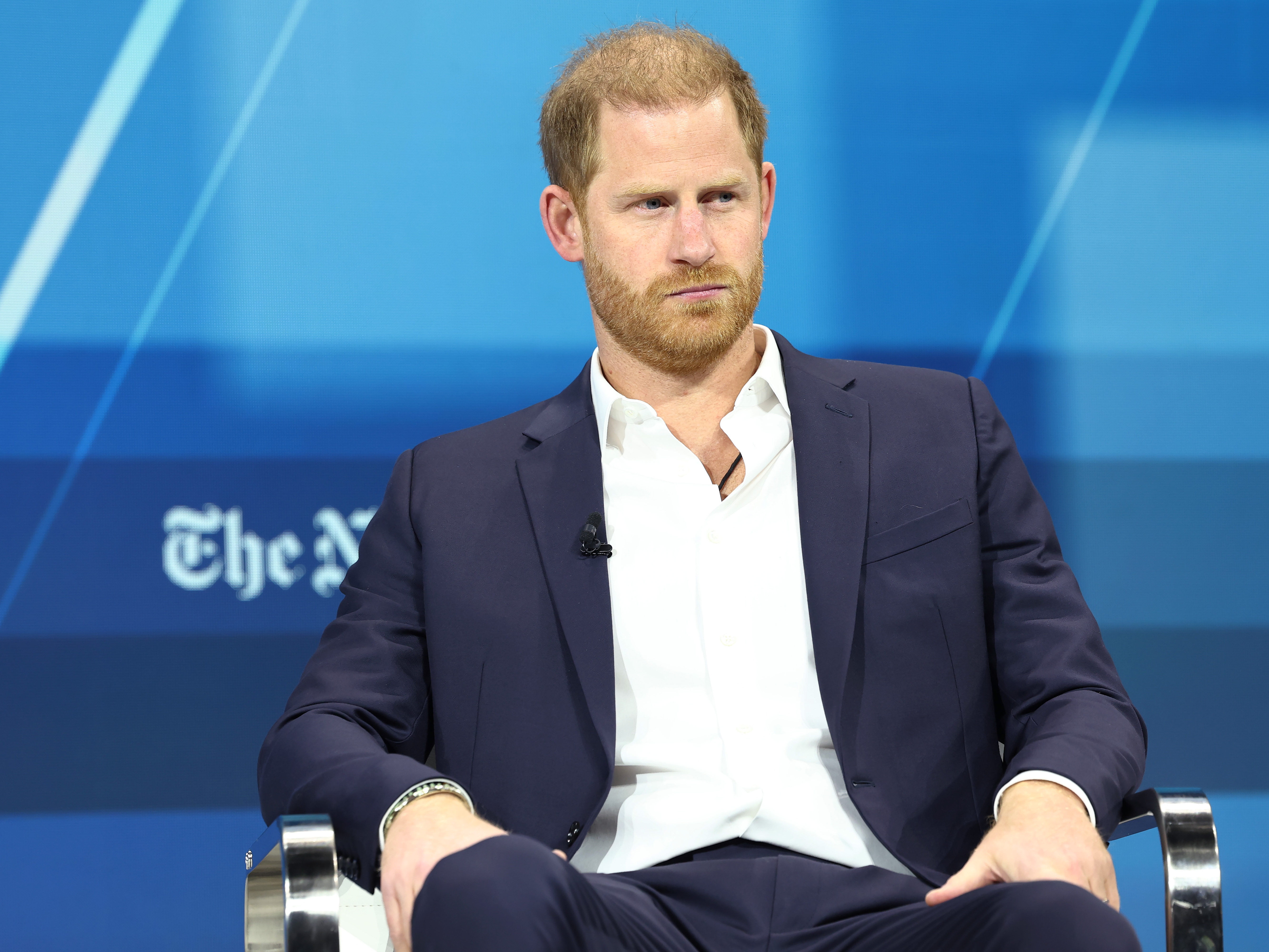 caption: Prince Harry said his lawsuit against Rupert Murdoch's British tabloids was about holding the media accountable, during the <em>New York Times</em> DealBook summit in December.