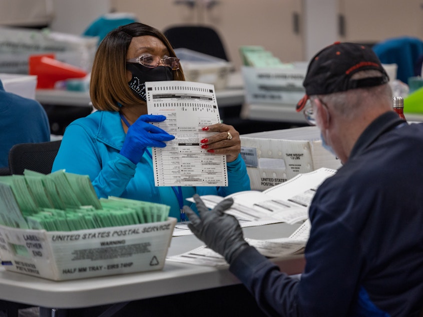caption: Election workers sort ballots at the Maricopa County Ballot Tabulation Center last week in Phoenix. The election is not considered over until the vote totals are reviewed and certified.