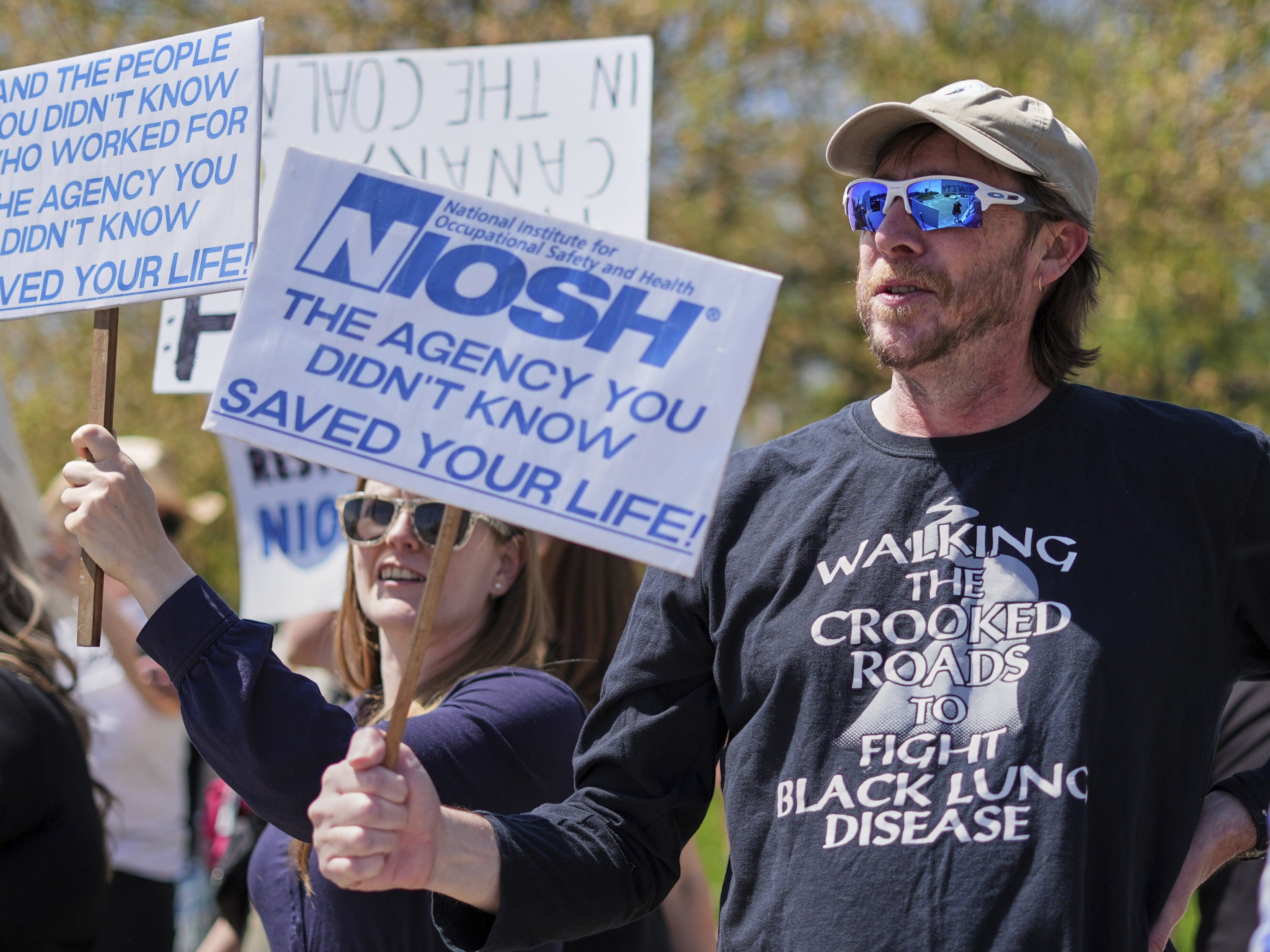 caption: Supporters march outside a National Institute for Occupational Safety and Health facility in Morgantown, W.Va.