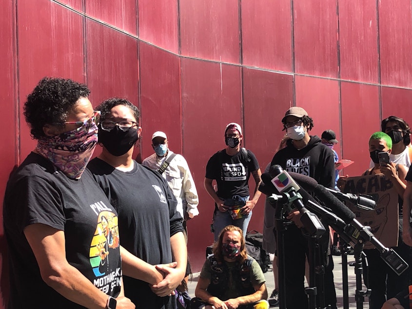 caption: Nicki Blake Chafetz (left) and Elliot Chafetz speak at a rally at Seattle City Hall, August 27, 2020. They are relatives of Jacob Blake, who was shot seven time in the back by police in Kenosha Wisconsin. 