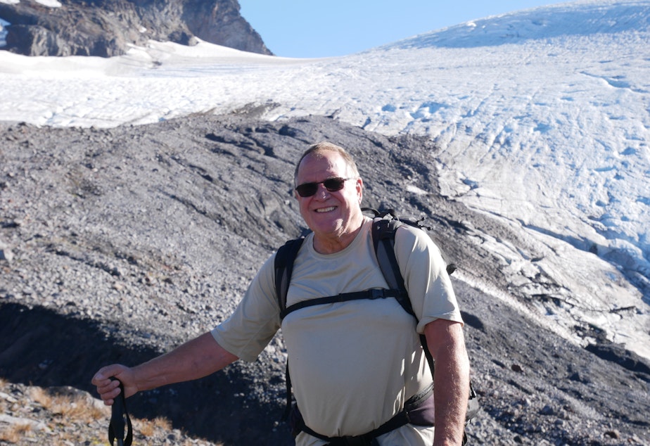 caption: Oliver Grah poses in front of the Sholes Glacier on Mount Baker on Sept. 23, 2021.
