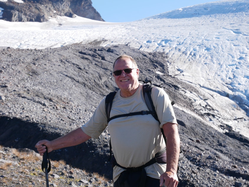caption: Oliver Grah poses in front of the Sholes Glacier on Mount Baker on Sept. 23, 2021.