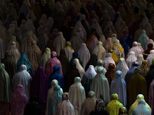 caption: Muslim women praying together in Istiqlal mosque, Jakarta, Indonesia.