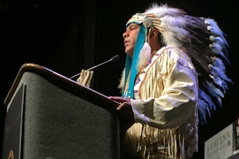 caption: JoDe Goudy, Yakama Nation Tribal Chairman, addresses the Alaska Federation of Natives in his full regalia in October 2016.