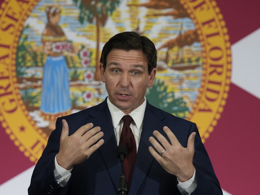 caption: Florida Gov. Ron DeSantis speaks during a news conference to sign several bills related to public education and teacher pay, in Miami, on May 9.