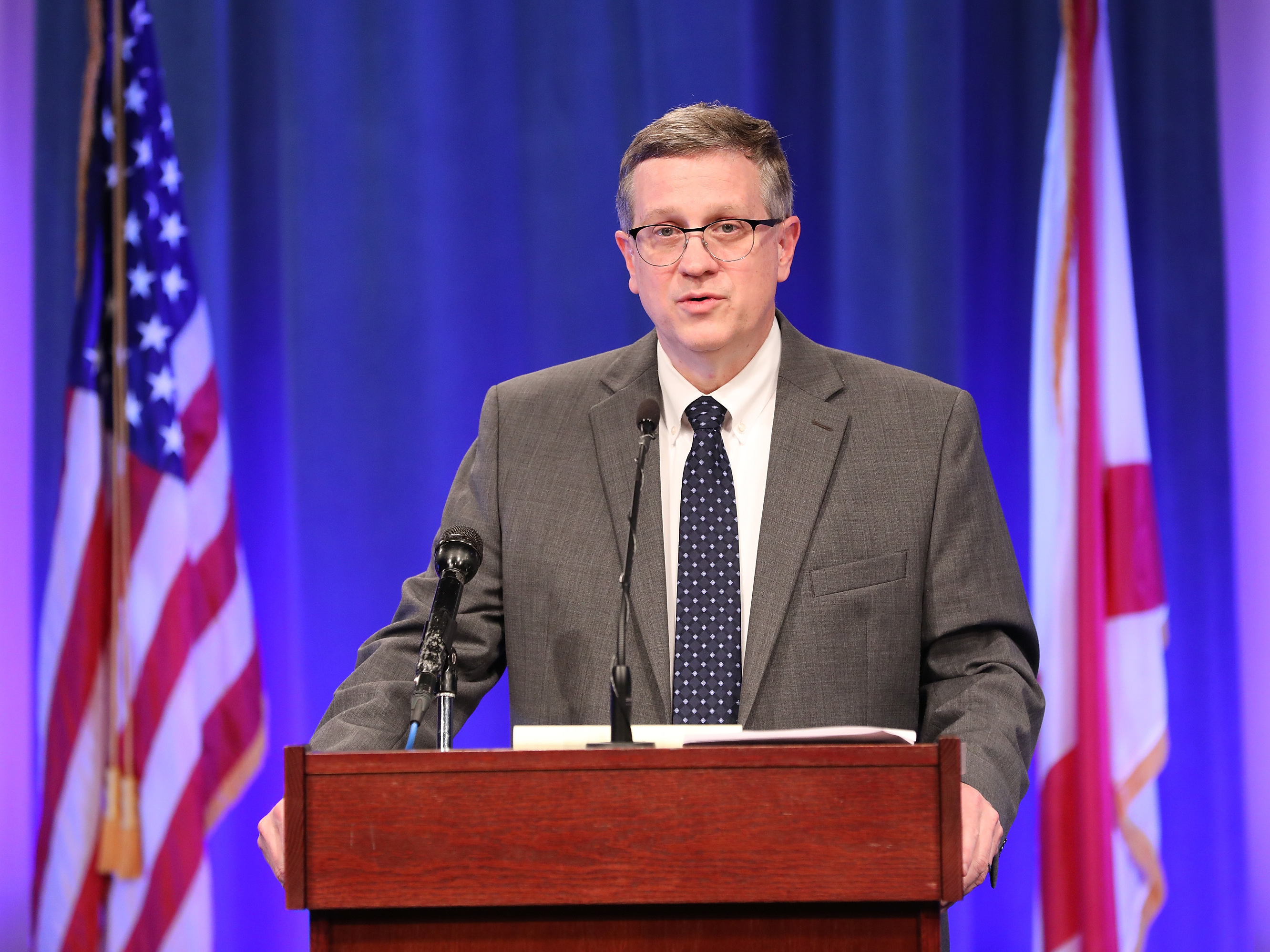 caption: Alabama State Health Officer Dr. Scott Harris updates Alabama's residents on COVID-19's spread in March, in Montgomery, Ala.