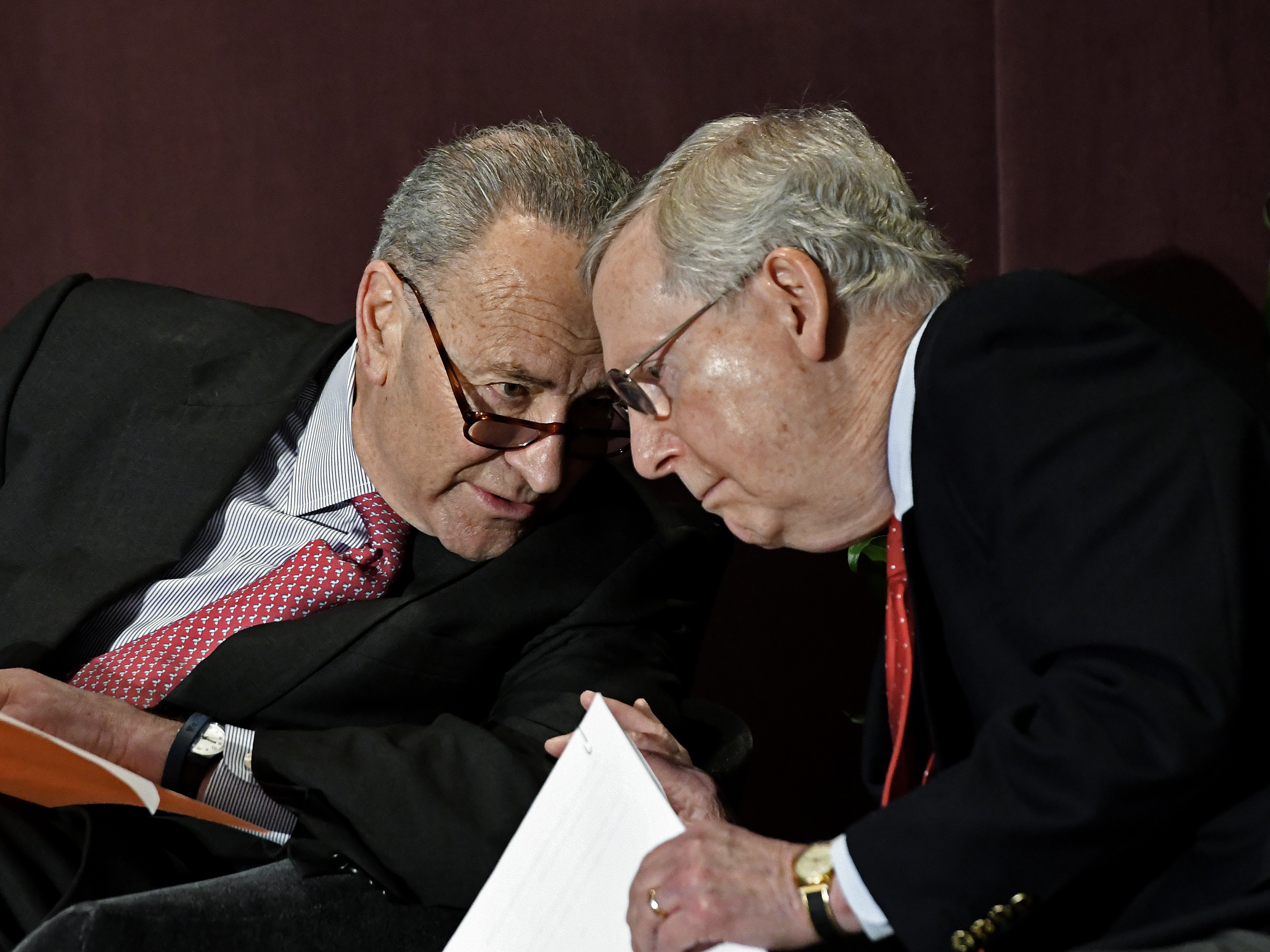 caption: Senate Minority Leader Charles Schumer speaks to Senate Majority Leader Mitch McConnell before his 2018 speech at the McConnell Center's Distinguished Speaker Series in Louisville, Ky.