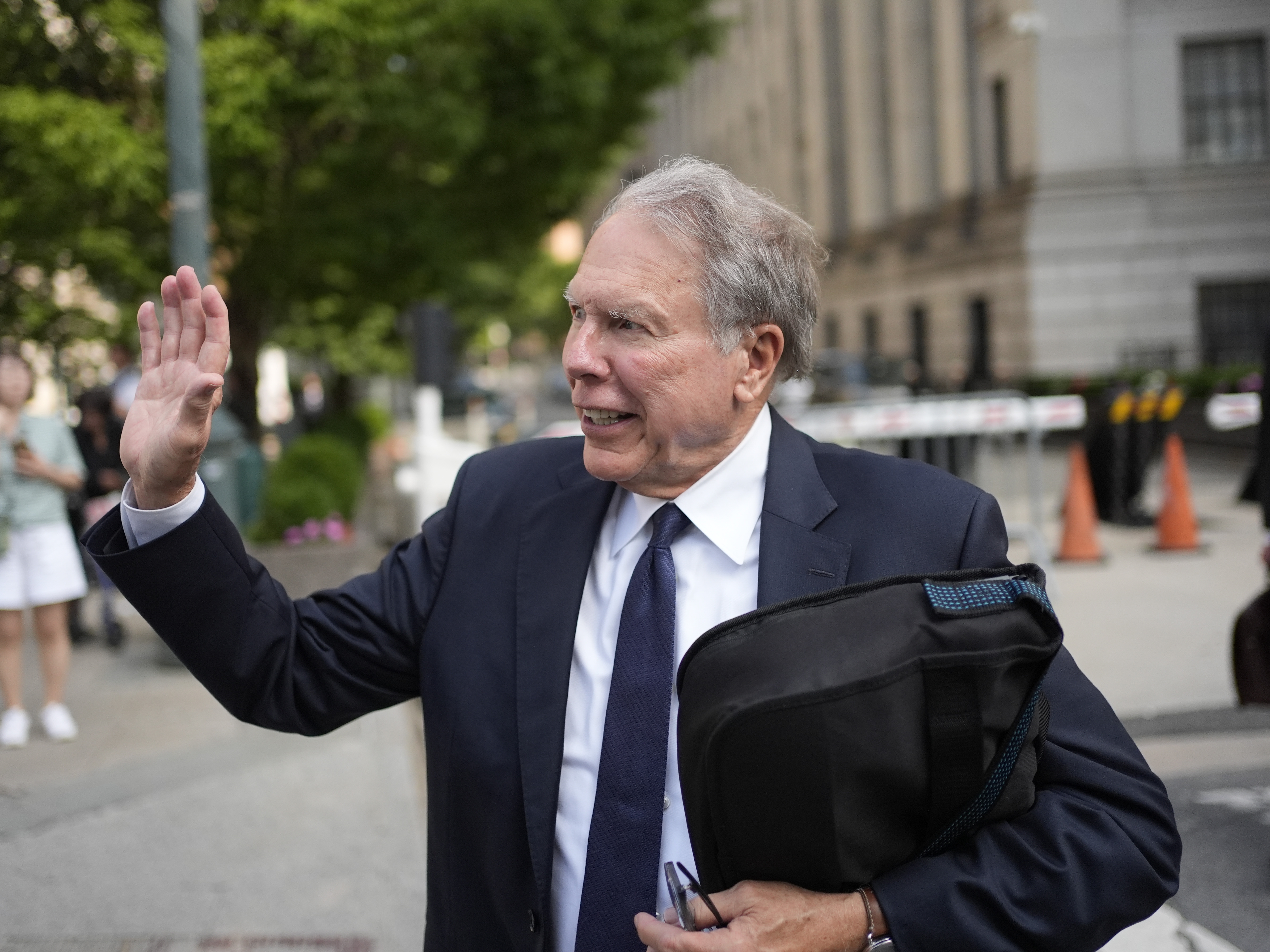caption: Wayne LaPierre, former CEO of the National Rifle Association, waves to someone as he leaves a courthouse in New York, Monday, July 29, 2024. A New York judge declined to appoint an outside monitor to oversee the finances and internal policies of the National Rifle Association. But he said he would bar LaPierre, the group's former leader, from holding a paid position in the organization for a decade.
