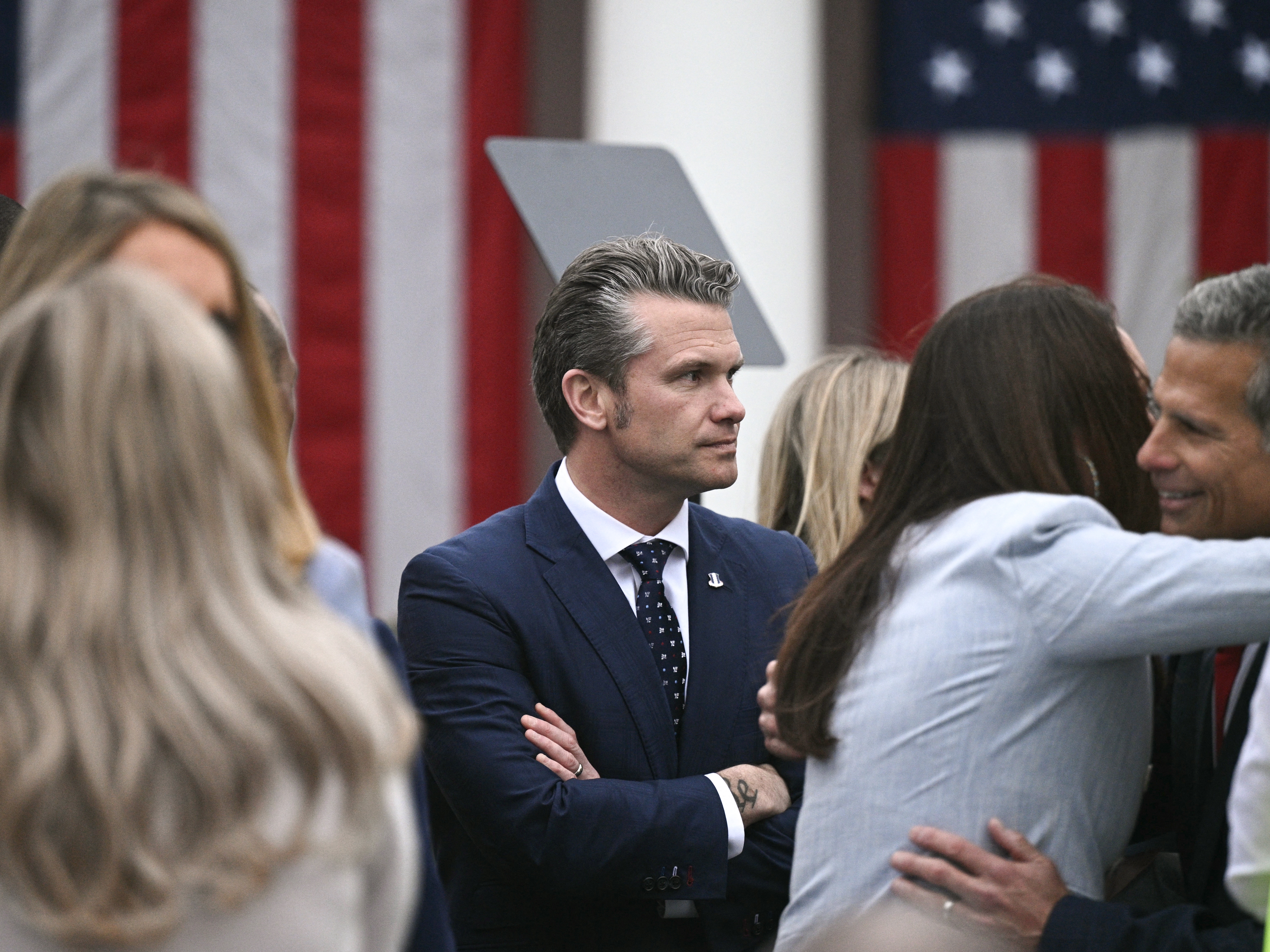 caption: Secretary of Defense Pete Hegseth attends a tariff announcement in the Rose Garden on Wednesday. A Defense Department inspector general has announced he will review Hegseth's use of the Signal messaging app to discuss a military attack on Yemen.