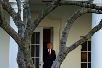 caption: President Trump emerges from the Oval Office on Wednesday as he departs the White House en route to Florida's Mar-a-Lago, where he will spend Christmas and New Year's Eve.