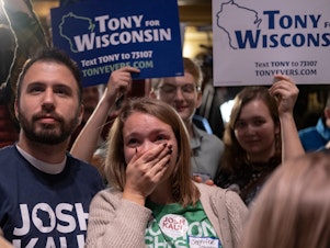 caption: Supporters react during an election night event for Democratic Gov. Tony Evers at The Orpheum Theater on Nov. 8 in Madison, Wisc. Evers defeated Republican challenger Tim Michels Tuesday.
