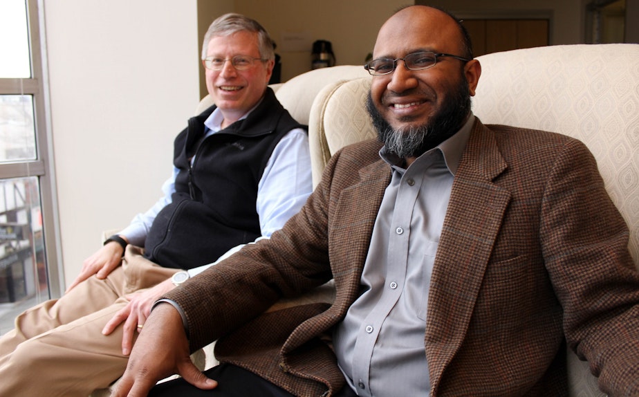 caption: Gordon Wilson sits next to Tanvir Rahman at the KUOW Studios.