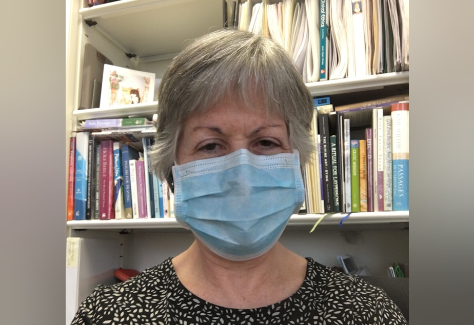 caption: 'I am smiling in this photo. Can you tell?' Deborah Thompson at Swedish Medical Center said safety precautions make it hard to comfort and communicate with patients right now. 