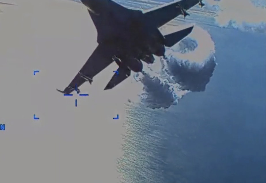 caption: A Russian Su-27 fighter jet releases fuel as it approaches the rear of a U.S. Air Force MQ-9, in what the Pentagon says was "an unsafe and unprofessional intercept" over the Black Sea.