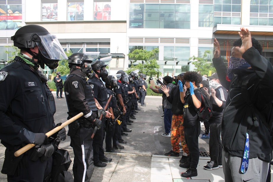 caption: Protesters face Bellevue Police  in downtown Bellevue Sunday, May 31, 2020. The crowd was protesting the death of an unarmed Black man, George Floyd, killed by police officers in Minneapolis. 