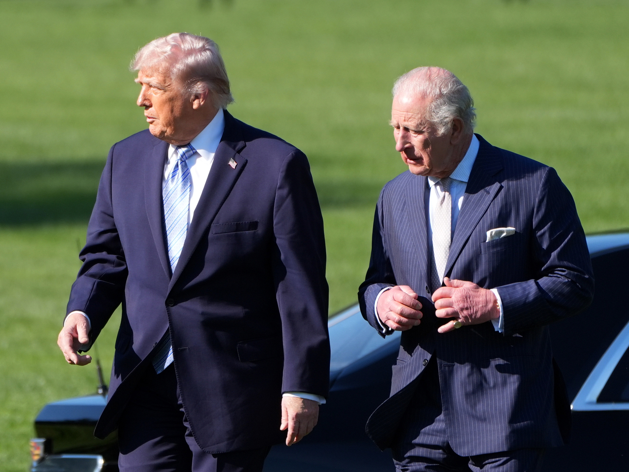 caption: U.S. President Donald Trump and King Charles III arrive to look at the White House garden and bee hive on the South Lawn of the White House.