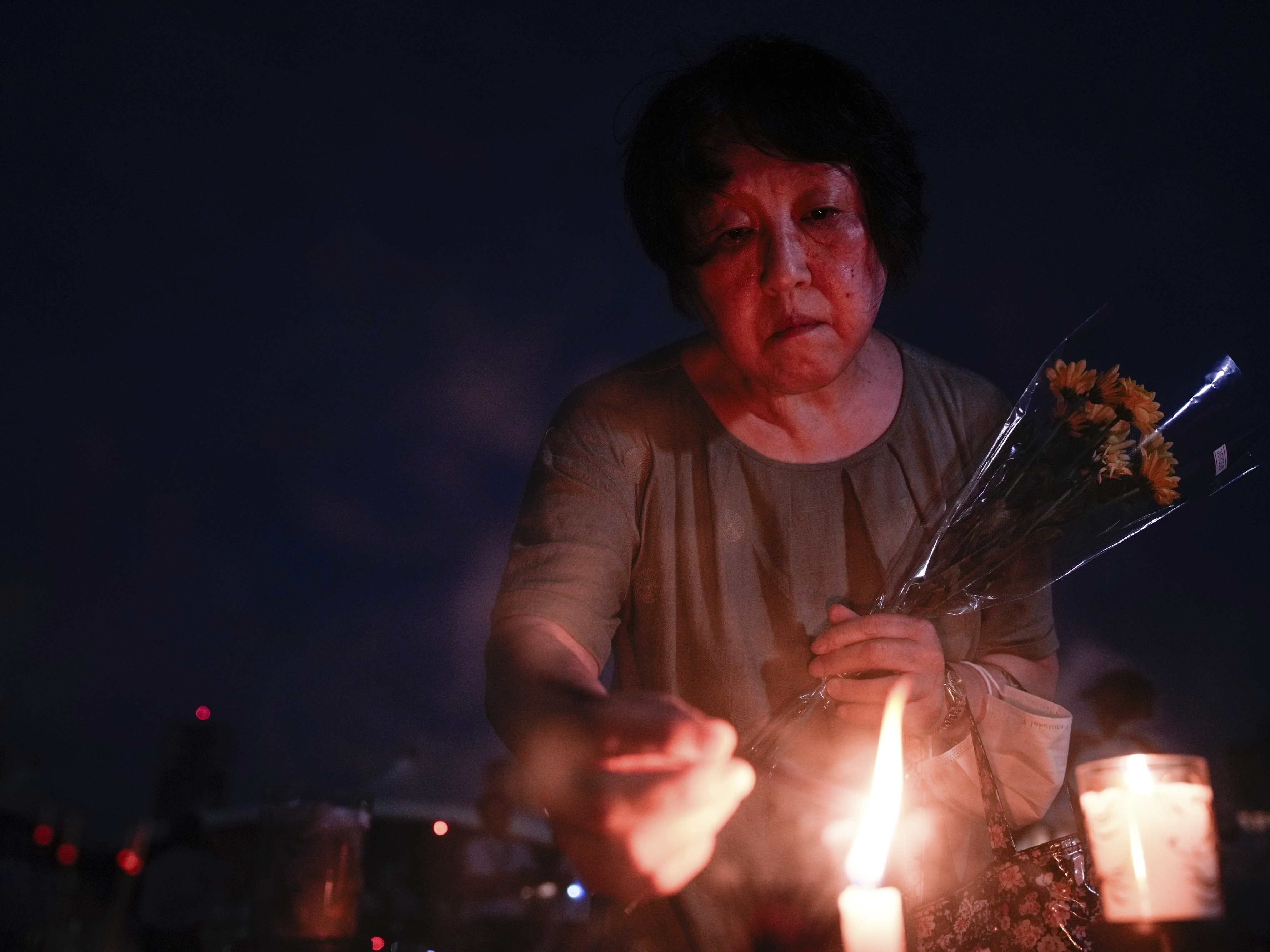 caption: A visitor lights incense sticks at the Peace Memorial Park ahead of the memorial service to mark the 80th anniversary of the WWII U.S. atomic bombing in Hiroshima, Wednesday, Aug. 6, 2025, in Japan.