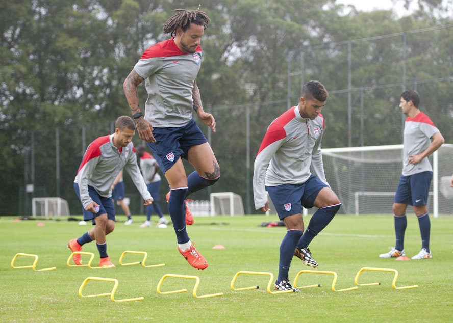 caption: DeAndre Yedlin (third from left) trains with the US National Team at the 2014 World Cup in Brazil.