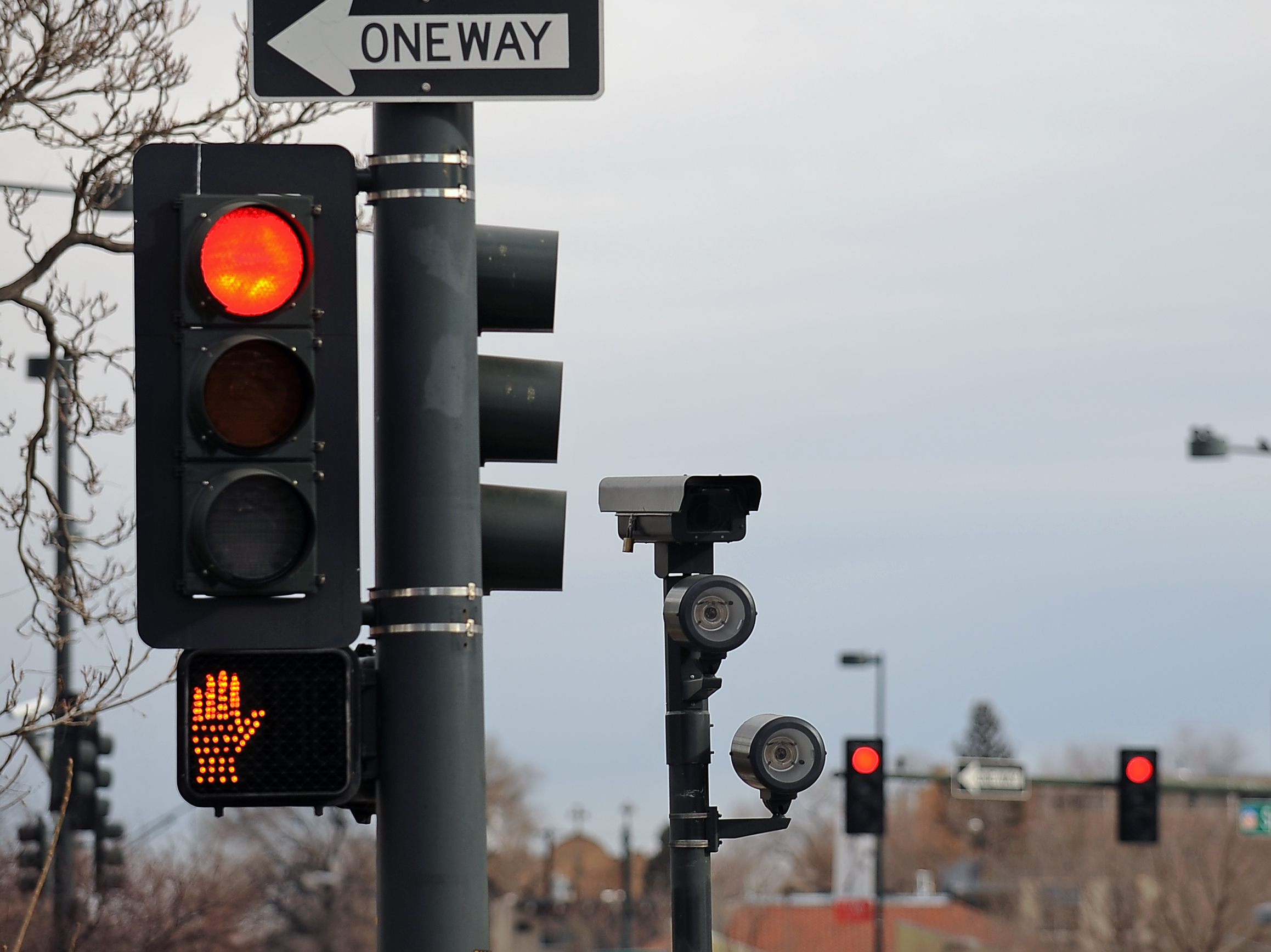 caption: This red light camera is at intersections of 6th Ave, Speer and Lincoln in Denver. A new study finds that deaths caused by motorists running red lights have risen to a 10-year-high.
