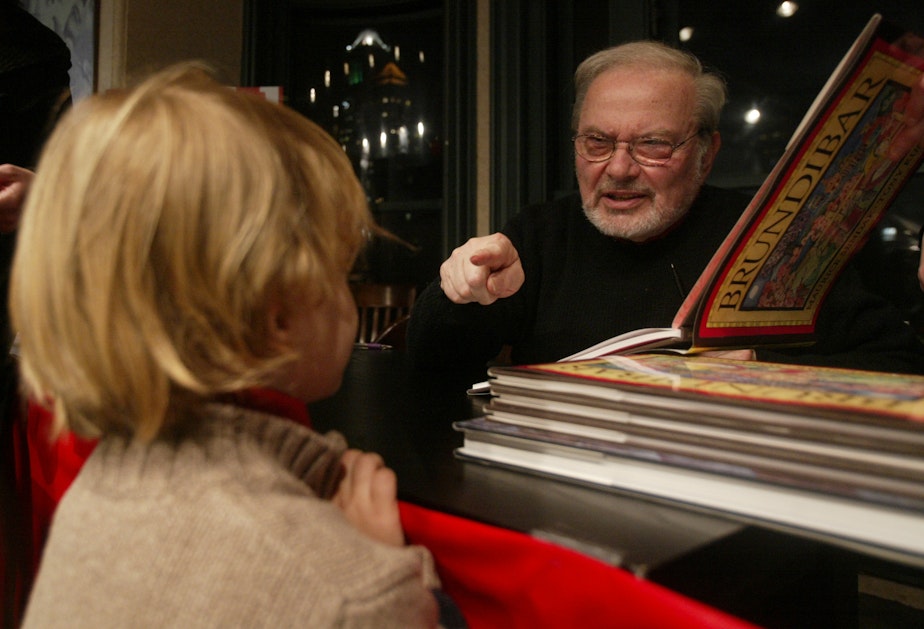 caption: Children's book author and illustrator Maurice Sendak, points to 3-year-old Marcus Gabrielli as he signed autographs in New York.