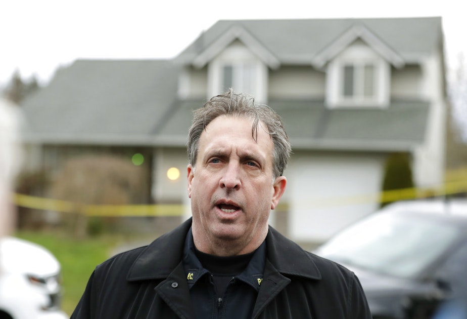 caption: Pierce County Sheriff's Dept. spokesman Ed Troyer talks to reporters, Tuesday, March 13, 2018, in front of the home in Spanaway, Wash., where authorities say a member of the U.S. Air Force, who was stationed at Joint Base Lewis-McChord, fatally shot his two young children and their mother before killing himself overnight. 