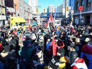 caption: Demonstrators opposed to the Canada's COVID-19 mandates block the streets of Ottawa as they continue to protest on Saturday.