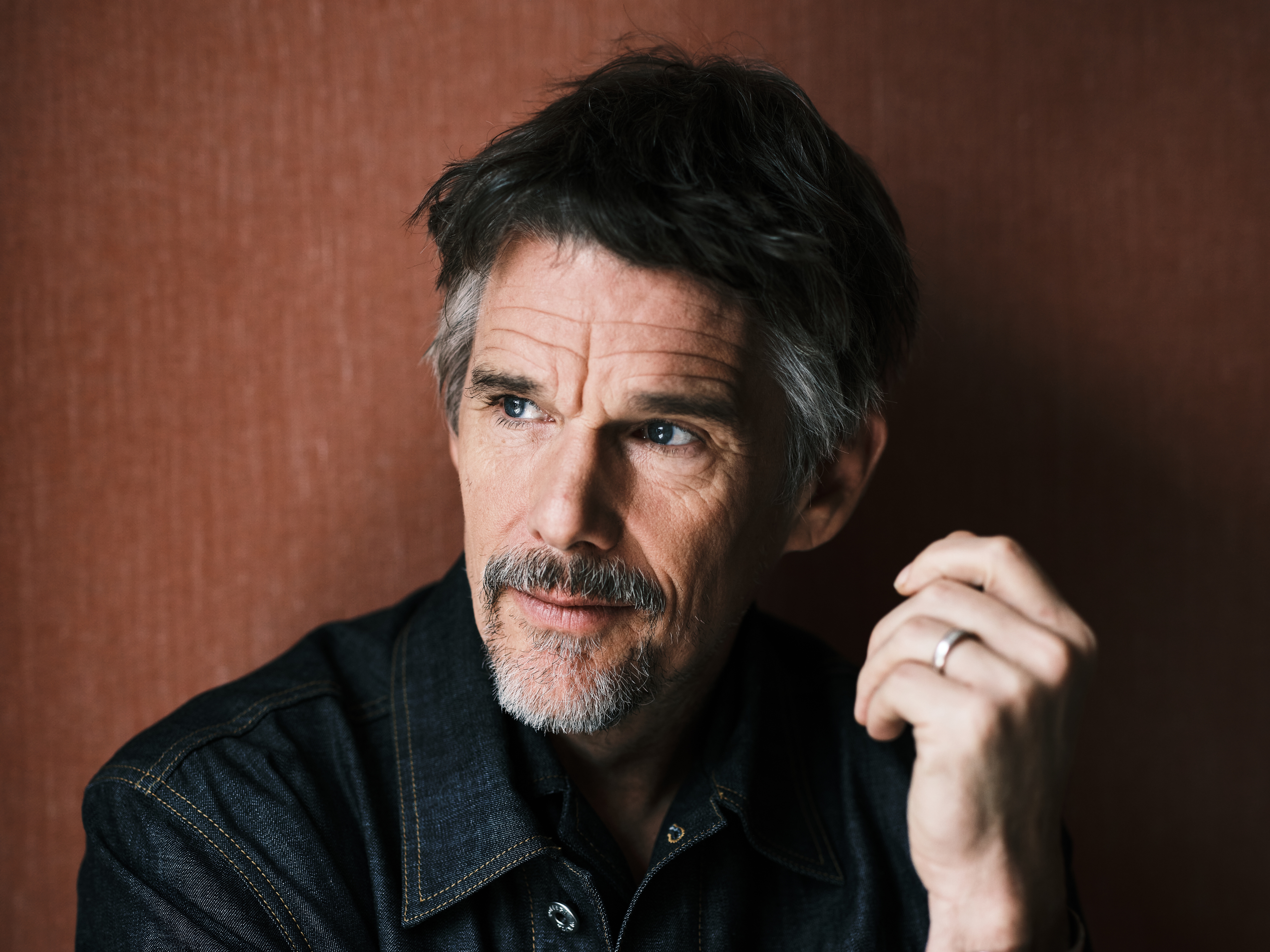 caption: Ethan Hawke has two movies out. He stars as lyricist Lorenz Hart in <em>Blue Moon</em>. In <em>Black Phone 2,</em> he plays a serial killer who dies and goes on to haunt people's dreams.