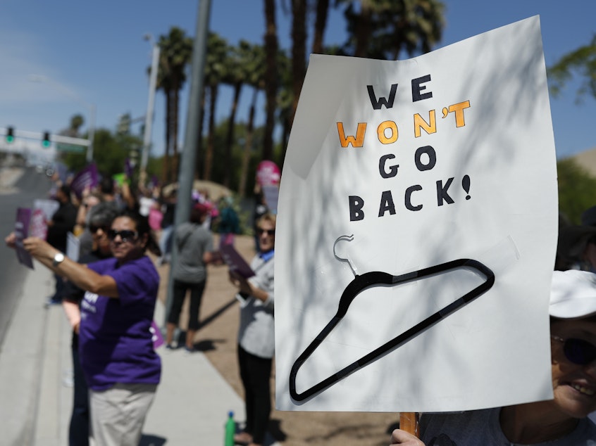 caption: People rally in support of abortion rights on Tuesday in Las Vegas.