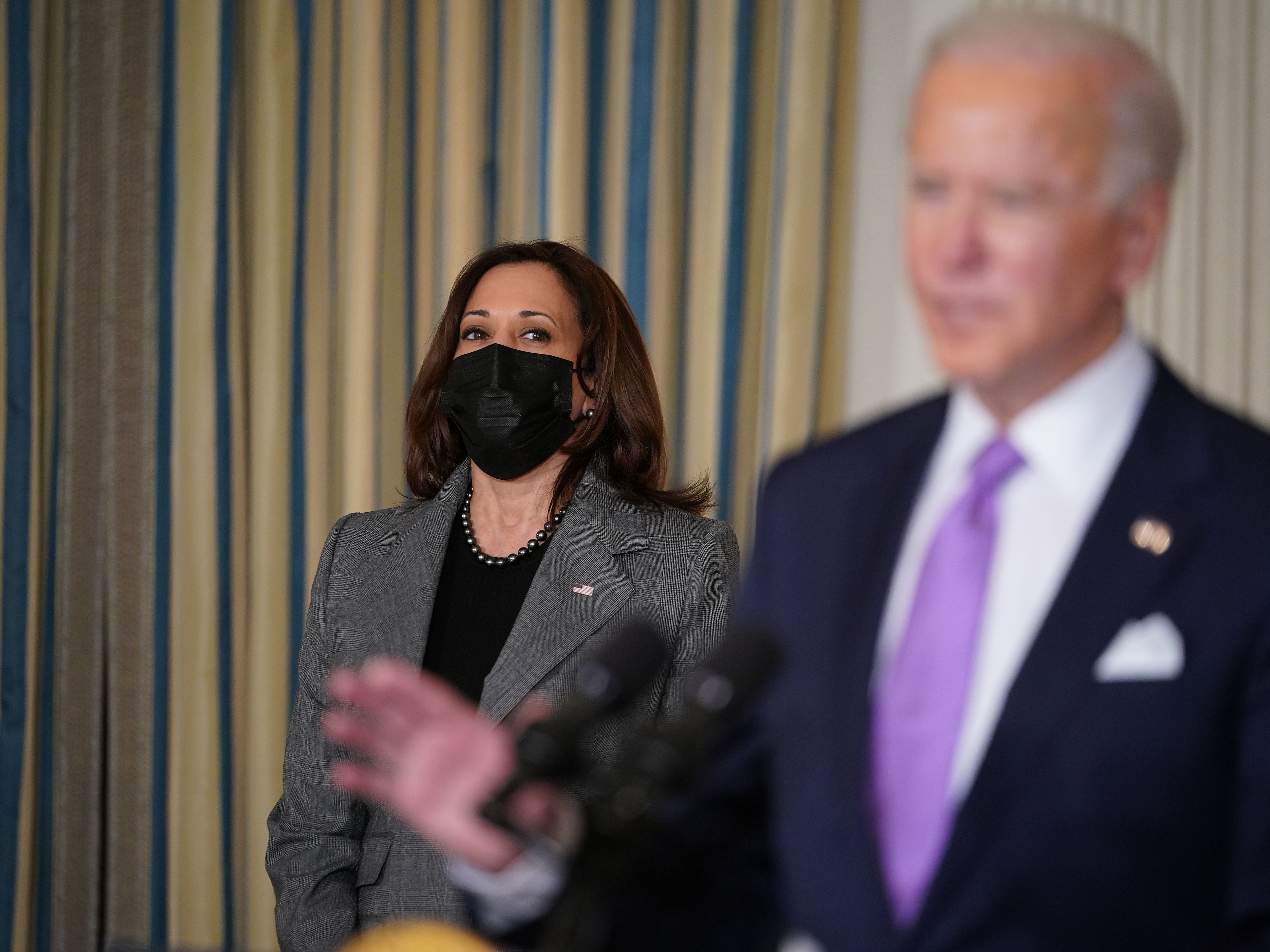 caption: Vice President Harris listens as President Biden speaks on racial equity before signing executive orders at the White House on Jan. 26, part of a largely traditional public role she has played since taking office two weeks ago.