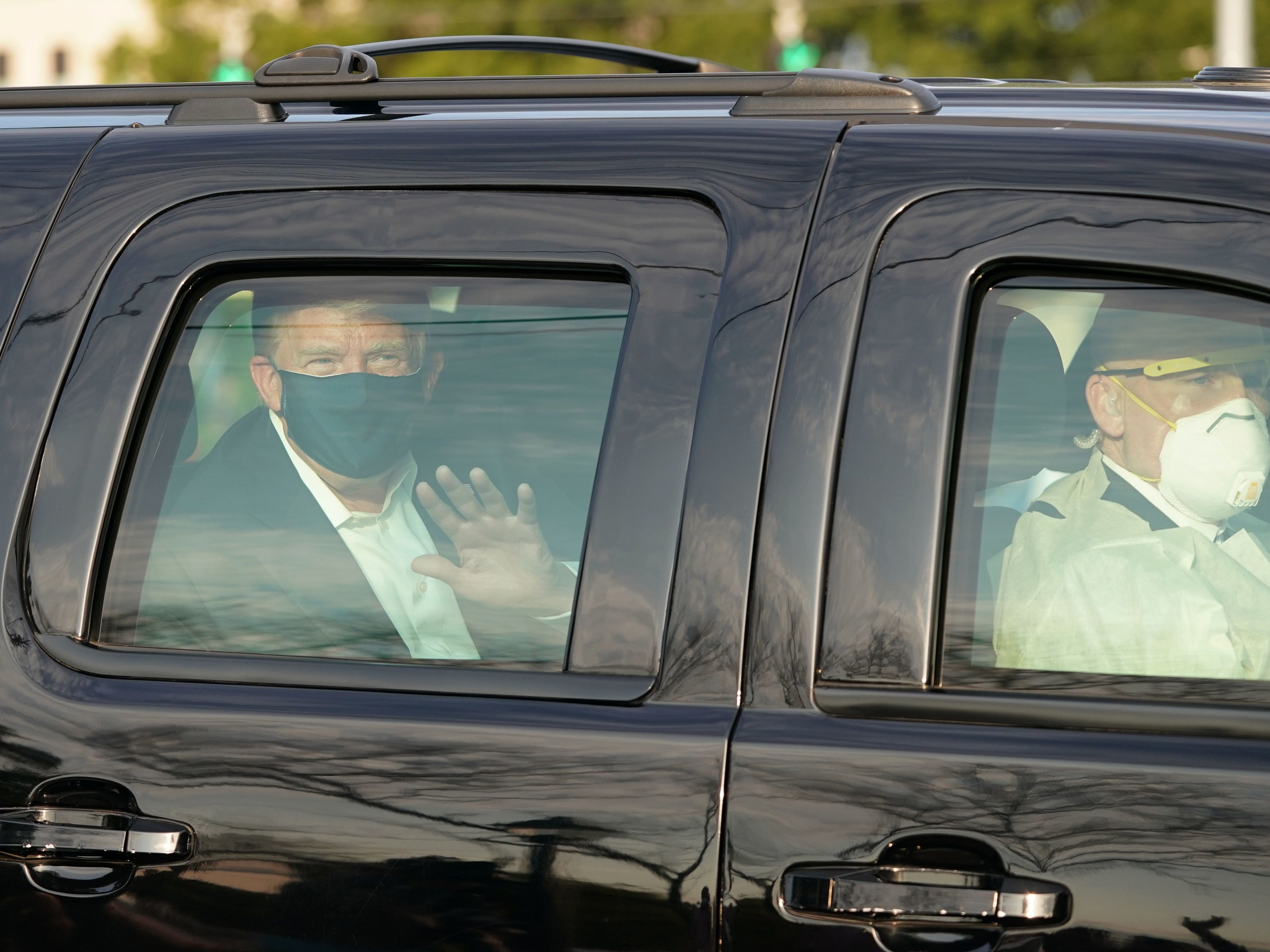 caption: Dr. James Phillips is no longer working at Walter Reed National Military Medical Center, months after criticizing President Trump's flouting of coronavirus safety guidelines. In October, Trump waved to supporters from the back of an SUV as he was driven outside the facility in Bethesda, Md..