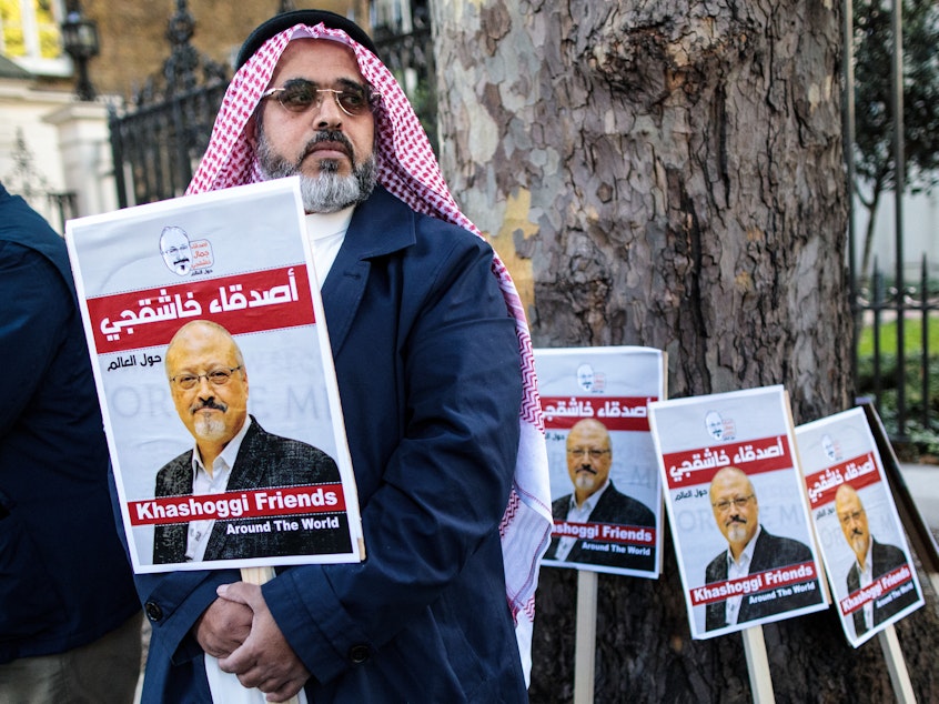 caption: Jamal Khashoggi's fiancee and others will speak about his life and legacy on Friday, one month after he was killed in Saudi Arabia's consulate in Istanbul. Here, a protester holds a placard showing solidarity for Khashoggi during a demonstration outside the Saudi Arabian Embassy in London last week.