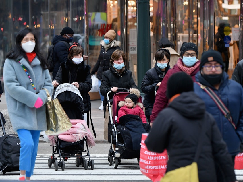 caption: People walk through a busy shopping area amid the coronavirus pandemic on Jan. 5 in New York City. Coronavirus cases are up in almost every state.