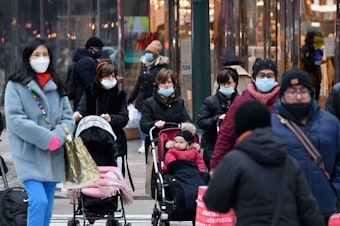 caption: People walk through a busy shopping area amid the coronavirus pandemic on Jan. 5 in New York City. Coronavirus cases are up in almost every state.