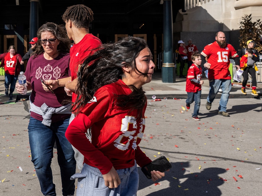 caption: People flee after shots were fired near the Kansas City Chiefs' Super Bowl victory parade on Wednesday in Kansas City, Mo.