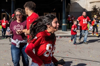 caption: People flee after shots were fired near the Kansas City Chiefs' Super Bowl victory parade on Wednesday in Kansas City, Mo.