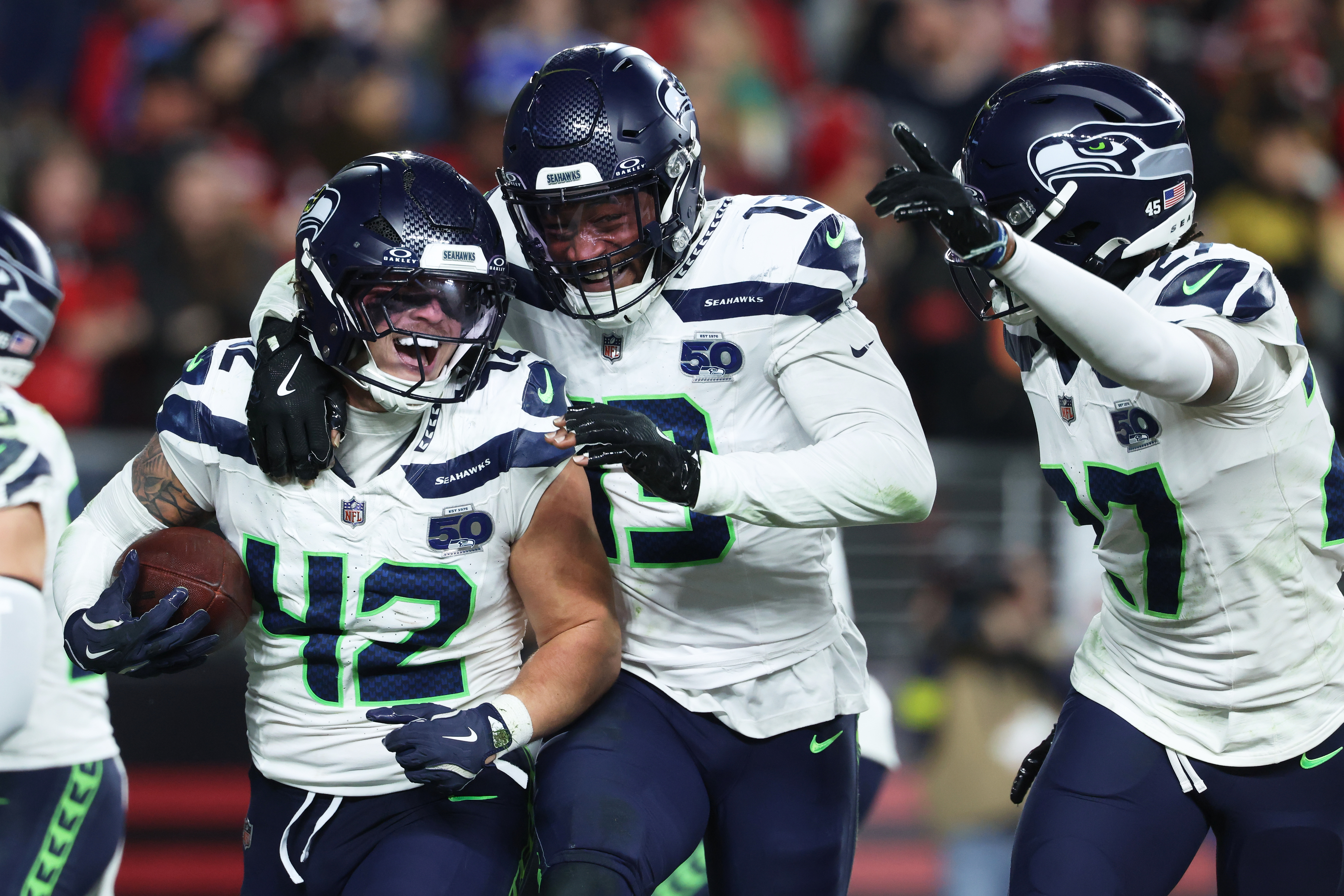 caption: Seattle Seahawks linebacker Drake Thomas (42) is congratulated by linebacker Ernest Jones IV, middle, and cornerback Riq Woolen after intercepting a pass against the San Francisco 49ers during the second half of an NFL football game in Santa Clara, Calif., Saturday, Jan. 3, 2026. 