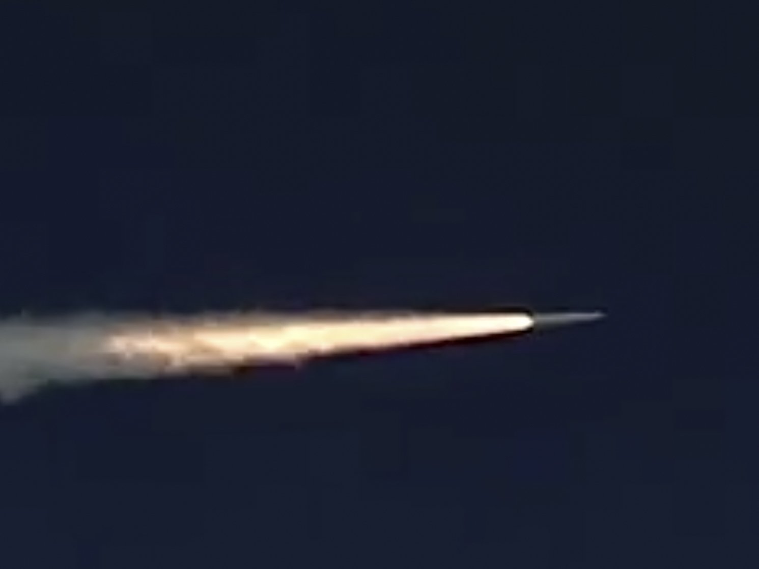 caption: In this 2018 photo made from footage taken from the Russian Defense Ministry's official website, a Russian Kinzhal hypersonic missile flies during a test in southern Russia.