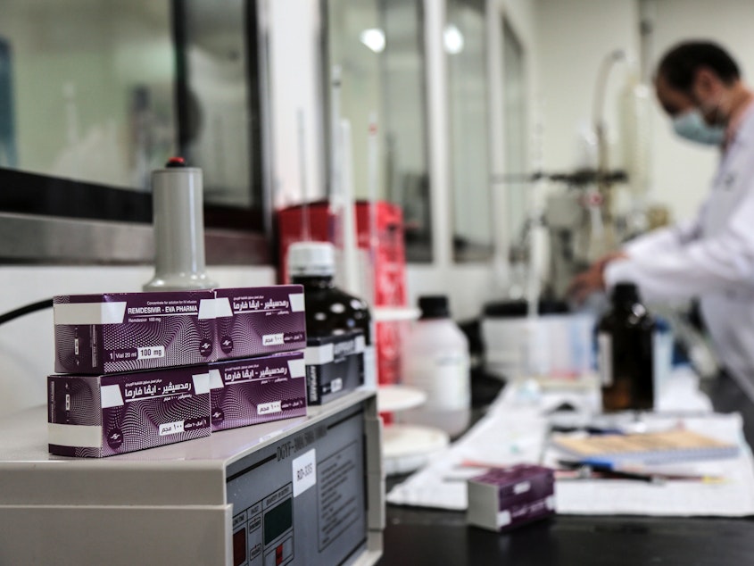 caption: Boxes containing vials of remdesivir at a pharmaceutical company in Giza, Egypt.